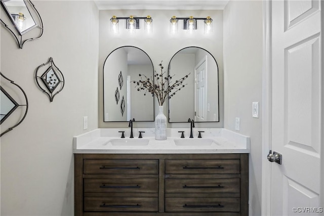 full bathroom featuring double vanity and a sink