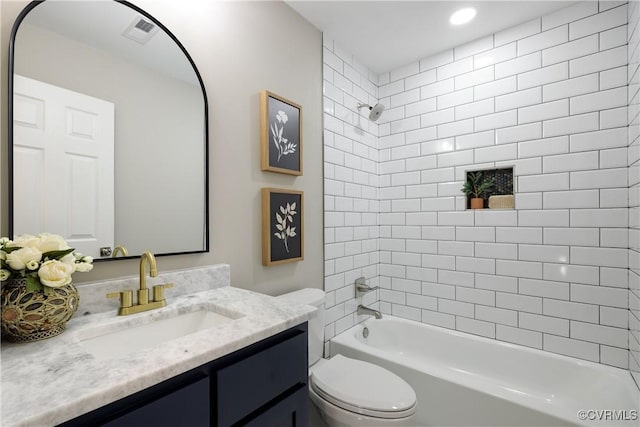 full bath with visible vents, toilet, vanity, and shower / bathing tub combination