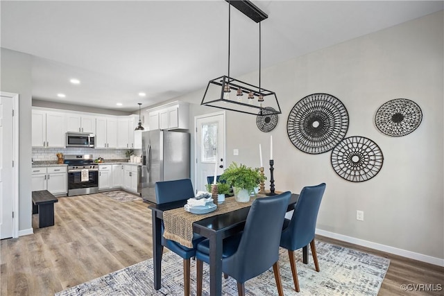 dining space featuring recessed lighting, baseboards, and light wood finished floors