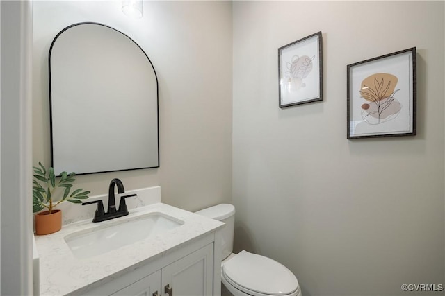 half bathroom with toilet and vanity