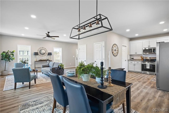 dining room featuring recessed lighting, a ceiling fan, light wood-type flooring, and baseboards