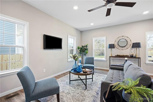 living room featuring visible vents, recessed lighting, ceiling fan, and wood finished floors