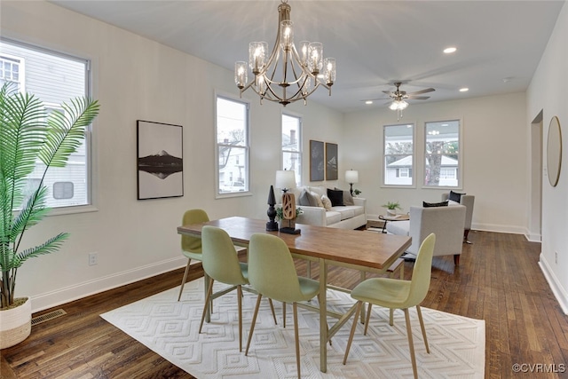 dining area featuring dark wood-type flooring, a healthy amount of sunlight, and visible vents