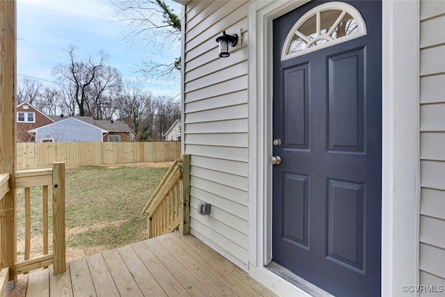 entrance to property with a yard and fence