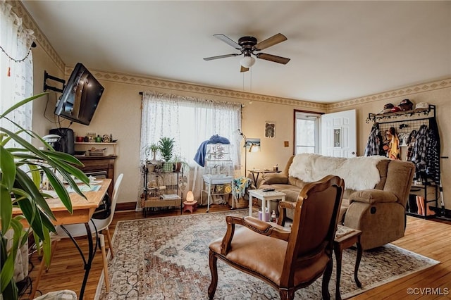 living room featuring wood finished floors and ceiling fan