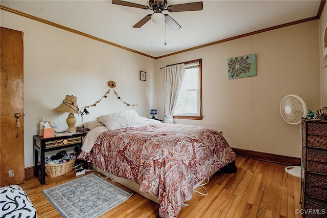 bedroom with hardwood / wood-style floors, baseboards, ornamental molding, and ceiling fan