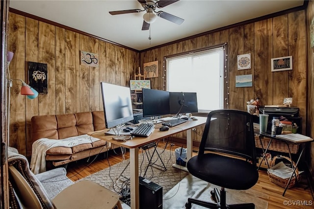 office with wooden walls, wood finished floors, and a ceiling fan