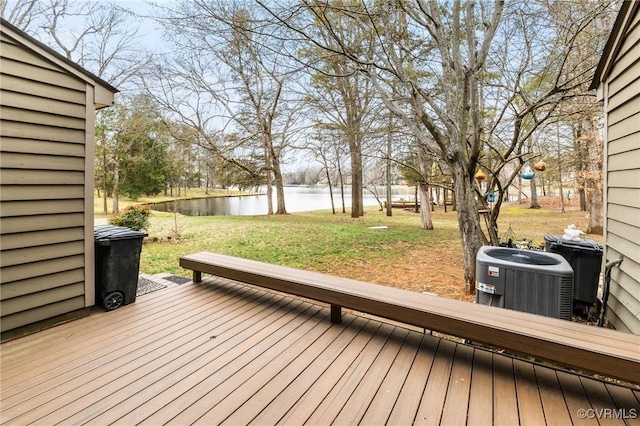 wooden terrace featuring central AC unit, a yard, and a water view