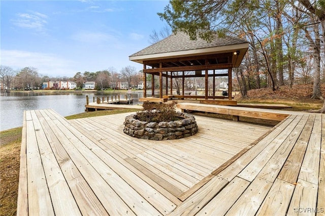 view of dock featuring a gazebo and a water view