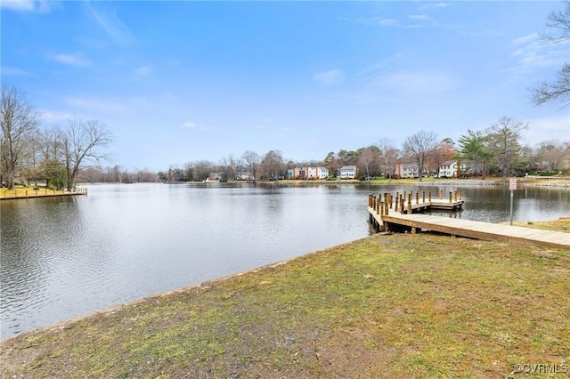 dock area featuring a yard and a water view