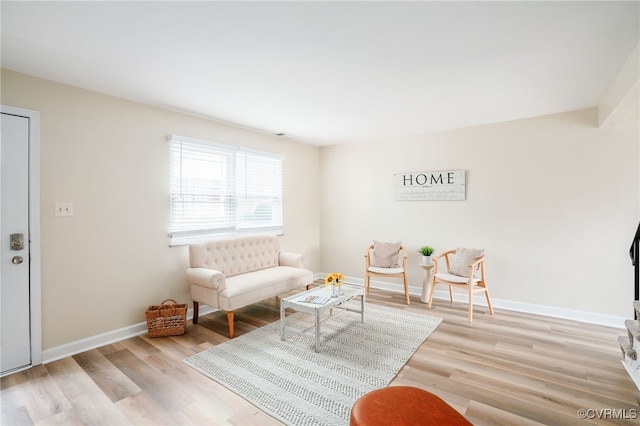 living room featuring baseboards and wood finished floors