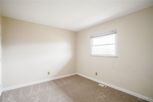 unfurnished room with visible vents, carpet flooring, and baseboards