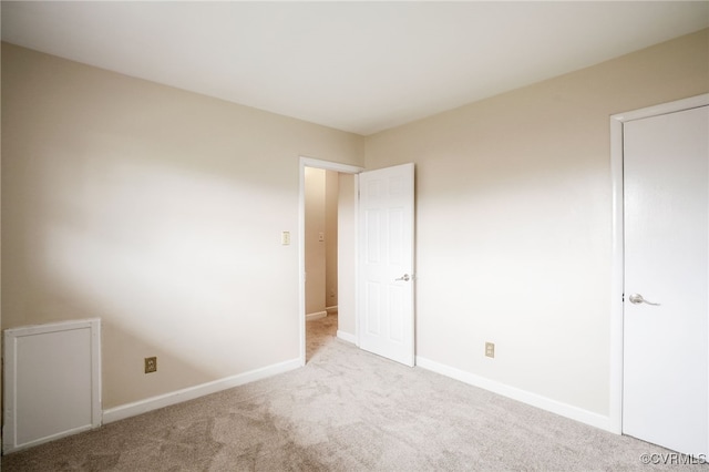 unfurnished bedroom featuring baseboards and carpet