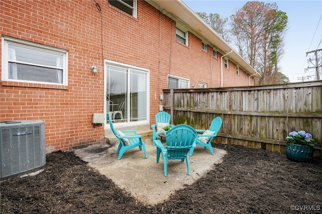 view of patio / terrace featuring central air condition unit and fence