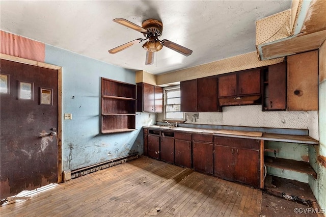 kitchen featuring open shelves, a sink, ceiling fan, dark brown cabinets, and wood-type flooring