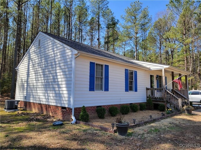 view of home's exterior with crawl space, a porch, and cooling unit