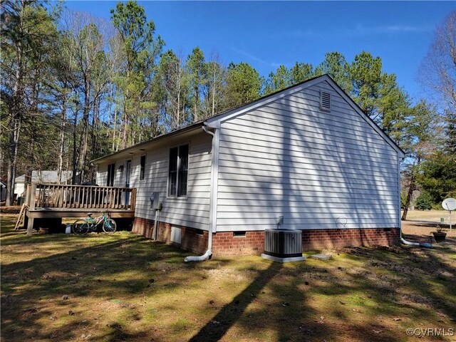 view of property exterior with crawl space, cooling unit, a yard, and a wooden deck