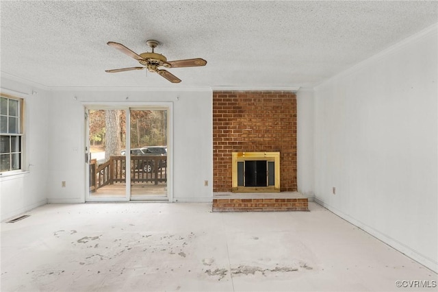 unfurnished living room featuring a ceiling fan, visible vents, a fireplace, a textured ceiling, and crown molding