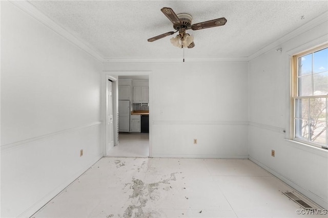 unfurnished room with visible vents, a wealth of natural light, and a textured ceiling