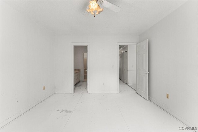 unfurnished bedroom featuring ceiling fan, baseboards, and ensuite bath