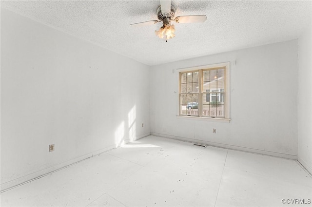 spare room with visible vents, a textured ceiling, and a ceiling fan