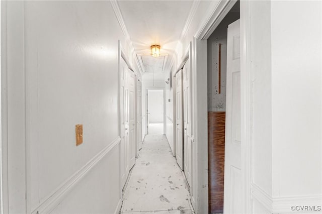 corridor featuring attic access and crown molding