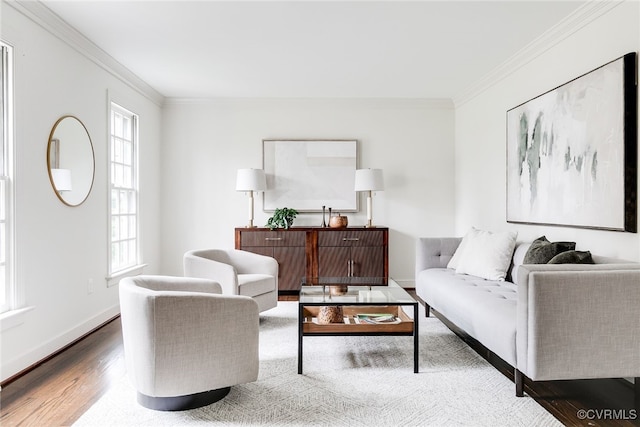 living room featuring wood finished floors, baseboards, and ornamental molding