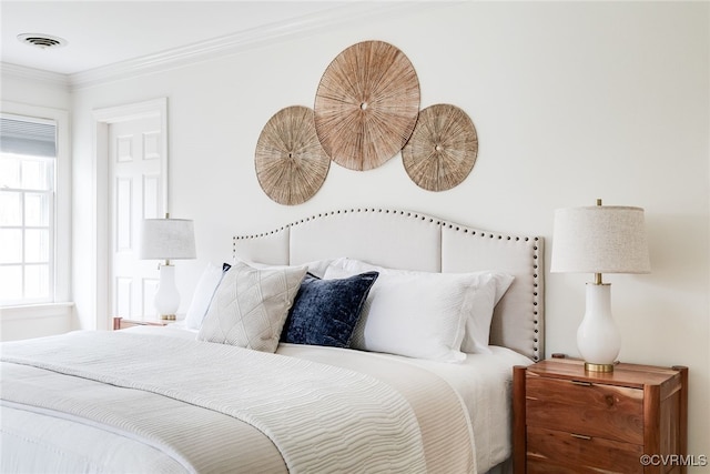 bedroom with visible vents and crown molding