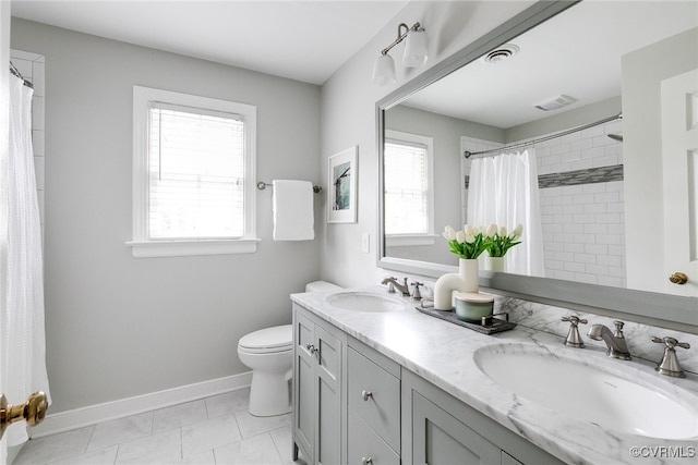 full bath with visible vents, baseboards, and a sink