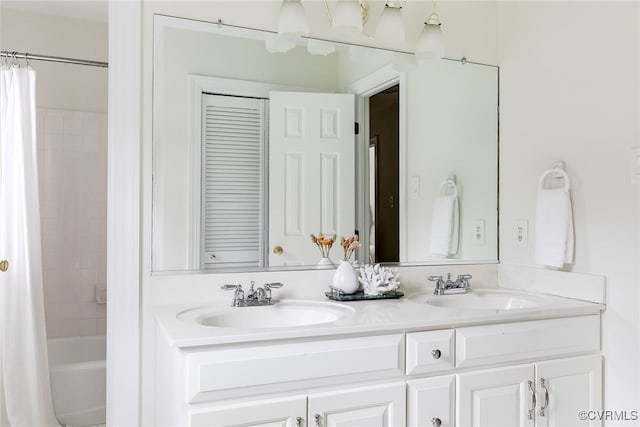 bathroom with a sink, double vanity, and shower / bath combination with curtain