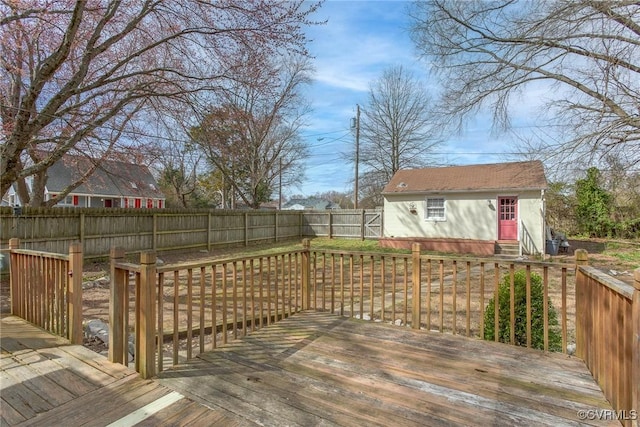 deck featuring an outbuilding and a fenced backyard