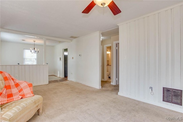 living room with light carpet, visible vents, and ceiling fan with notable chandelier