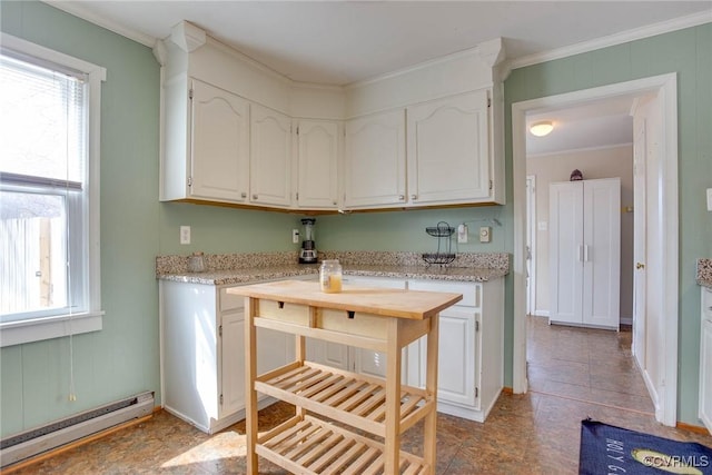 kitchen featuring a baseboard radiator, ornamental molding, and white cabinets