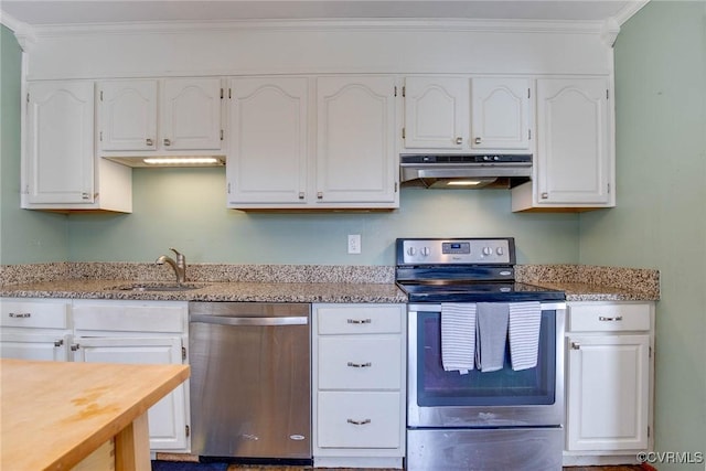 kitchen featuring under cabinet range hood, white cabinets, appliances with stainless steel finishes, and a sink