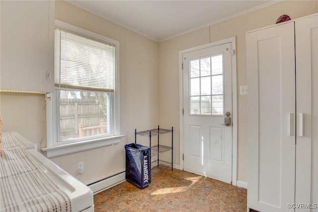 doorway with baseboard heating and crown molding