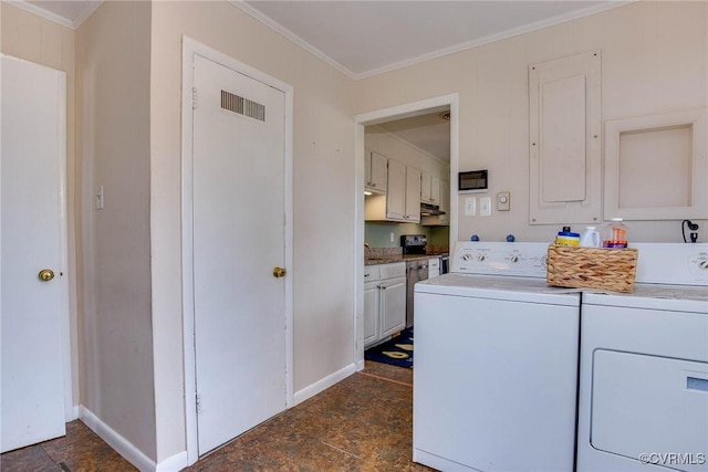 washroom featuring baseboards, electric panel, cabinet space, ornamental molding, and washer and dryer