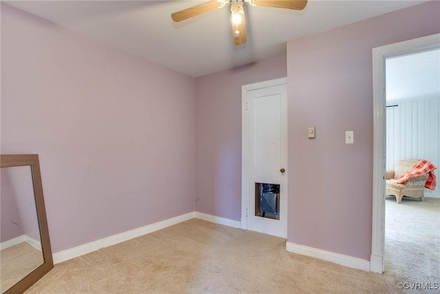 unfurnished room with ceiling fan, baseboards, and light carpet