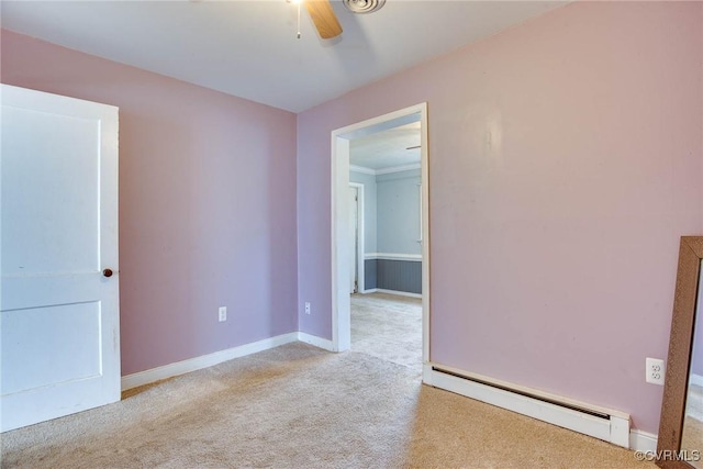 spare room with carpet, a ceiling fan, baseboards, and baseboard heating