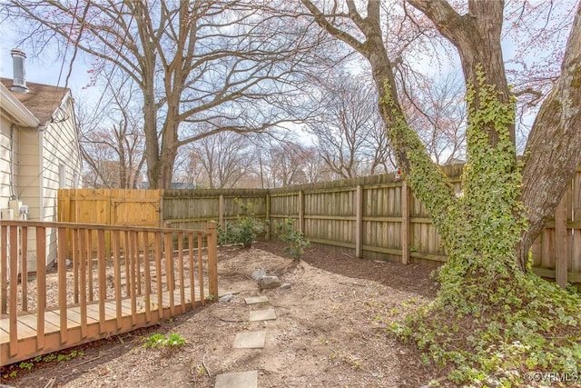 view of yard with a deck and a fenced backyard