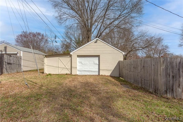 detached garage featuring fence