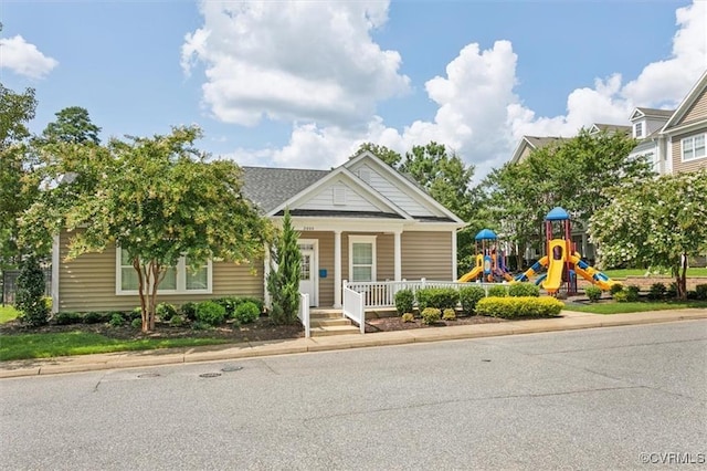 view of front facade featuring a porch and a playground