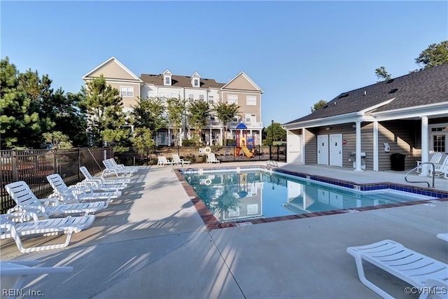 community pool featuring a patio and fence