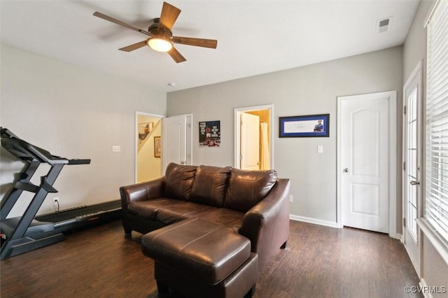 living room with a ceiling fan, wood finished floors, visible vents, and baseboards