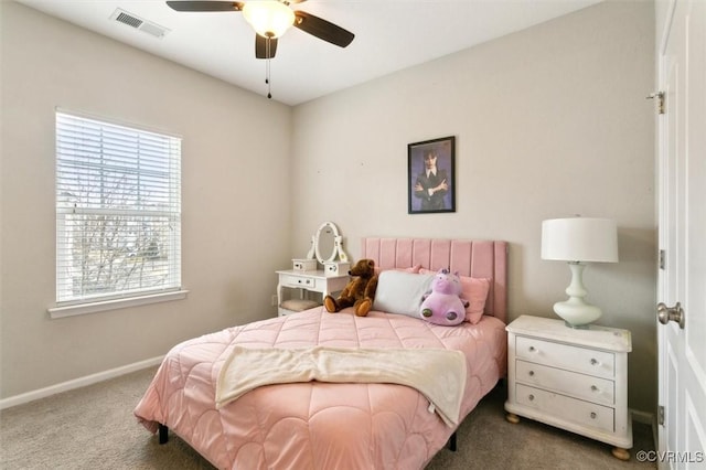 carpeted bedroom with visible vents, baseboards, and ceiling fan