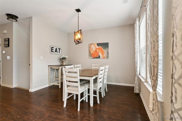 dining room with an inviting chandelier, baseboards, and wood finished floors