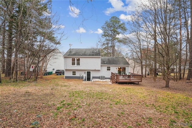 rear view of property with a lawn and a deck