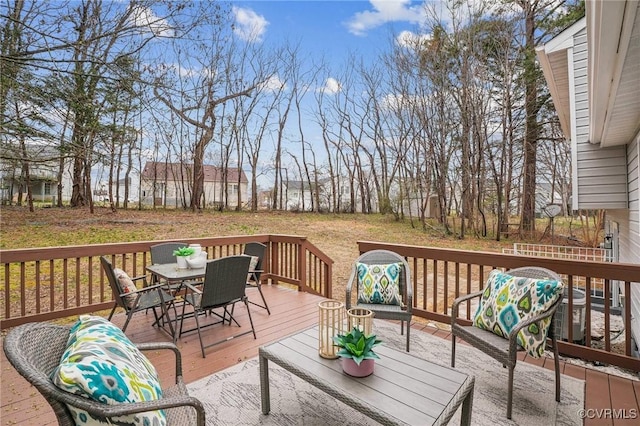 wooden terrace featuring outdoor dining area