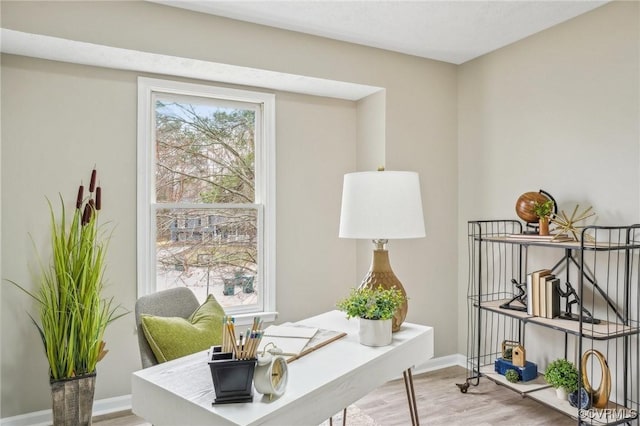 home office with light wood-style floors and baseboards