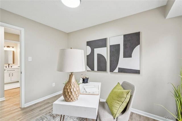 living area featuring baseboards and wood finished floors