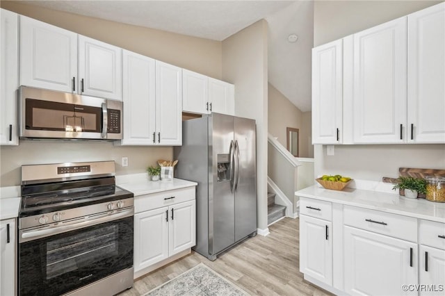 kitchen featuring light countertops, white cabinets, and stainless steel appliances